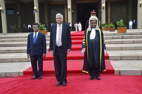 Sri Lanka's newly elected president Ranil Wickremesinghe, flanked by Parliament General Secretary Dhammika Dasanayake, left, and Parliament Speaker Mahinda Yapa Abeywardana. (Photo | AP)