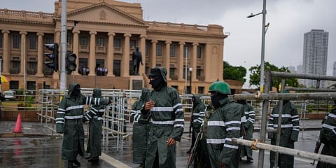 Army soldiers stand guard after removing protesters and their tents from the site of a protest camp outside the Presidential Secretariat in Colombo. (Photo | AP)