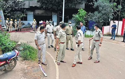Police officers at Tarihal Industrial Area where a fire broke out in a sparkle candle factory on Saturday | Express