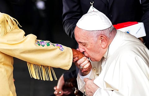 Pope Francis kisses the hand of residential school survivor Elder Alma Desjarlais of the Frog Lake First Nation as he arrives in Edmonton, Alberta, Canada, Canada, on July 25, 2022. (Photo | AP)