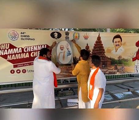 A BJP office-bearer on Wednesday affixed portraits of PM Narendra Modi on billboards put up as part of the TN government's publicity campaign for the 44th Chess Olympiad. (Photo | Special arrangement,