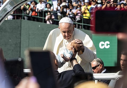 Participants paraded a long red banner through the grounds bearing the names of more than 4,000 children who died at or never came home from residential schools; Francis later kissed it. (Photo | AP)