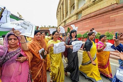 BJP MPs during a protest against Congress leader Adhir Ranjan Chowdhury's remarks on President Droupadi Murmu, at Parliament House, in New Delhi. (Photo | PTI)