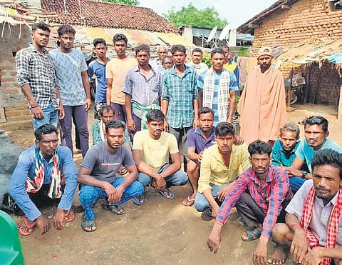 The workers protesting before SHG president’s house in Kotagaon. (Photo | Express)