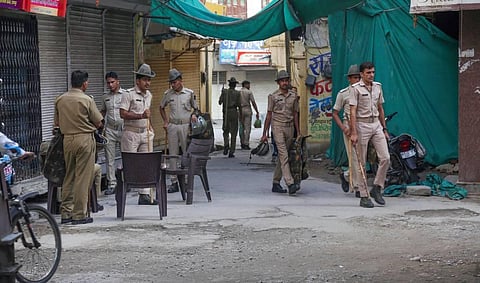 Security personnel deployed outside the closed shop of tailor Kanhaiya Lal during a ten-hour relaxation in the curfew imposed by administration. (Photo | PTI)