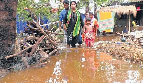 People of Musadiha village wade through polluted water released by AMNS. (Photo | Express)