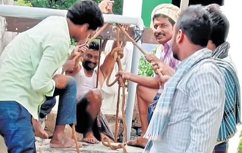 Gram Panchayat members and villagers clean a well at Futagao Badni village near Lakshmeshwar town in Gadag district.