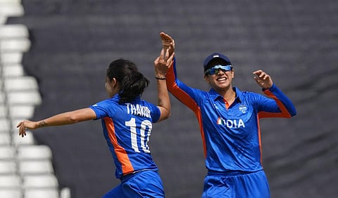 India's Renuka Singh Thakur, left, celebrates the dismissal of Australia's Beth Mooney during the women's cricket T20 preliminary round match between India and Australia. (Photo | AP)
