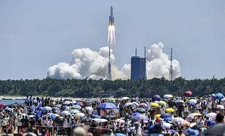 Onlookers watch the launch of a rocket transporting China’s second module for its Tiangong space station from the Wenchang spaceport in southern China. (Photo | AFP)
