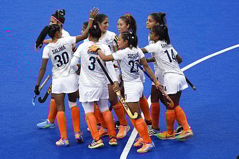 India's Kaur Gurjit, (2), is mobbed by teammates after she scores her sides second goal during the pool A women's hockey match between India and Wales. (Photo | AP)