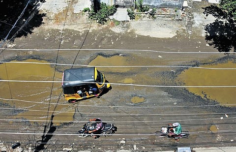 Motorists navigating a damaged section of the Nemilicherry high road at Chromepet. (Photo| Ashwin Prasath, EPS)