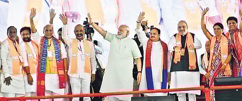 BJP leaders K Laxman, G Kishan Reddy, Rajnath Singh, Bandi Sanjay, Narendra Modi, JP Nadda, Amit Shah, DK Aruna and Piyush Goyal wave to the crowd at the ‘Vijaya Sankalpa Sabha, at the Parade Grounds