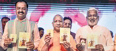 UP CM Yogi Adityanath, Deputy CM KP Maurya and UP BJP president Swatantra Dev Singh release booklet highlighting work done by BJP government. (Photo | PTI)
