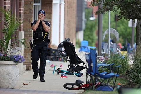 Police officer walks down Central Ave in Highland Park, Ill., on Monday, July 4, 2022, after a shooter fired on the northern suburb's Fourth of July parade. (Photo | AP)