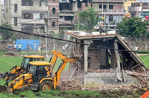 Bulldozers being used to demolish illegal structures during an anti-encroachment drive, at Nepali Nagar in Patna, Monday, July 4, 2022. (Photo | PTI)