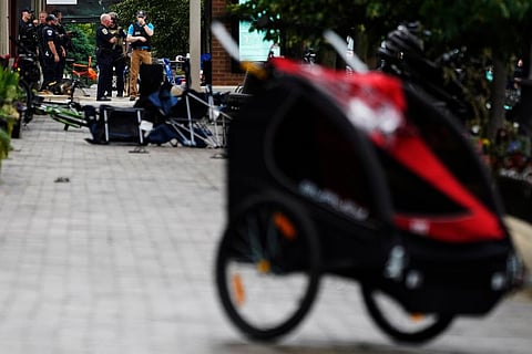 A police officer reacts as he walks in downtown Highland Park, a suburb of Chicago,  where a mass shooting took place at a Highland Park Fourth of July parade. (Photo | AP)