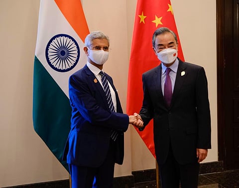 MEA Jaishankar greeting FM Wang Yi of China, in Bali. (Photo | Twitter)