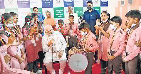 PM Narendra Modi with students at inauguration of Akshay Patra Mid-Day Meal Kitchen centre in Varanasi on Thursday. (Photo | PTI)