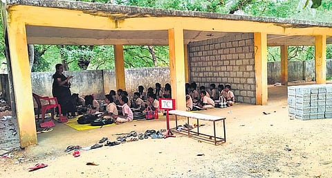 Classes take place in the bicycle stand of Government Higher Secondary School in Paranam village. (Photo| EPS)