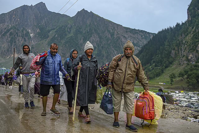 A fresh batch of Amarnath Yatra pilgrims left from the Jammu base camp on July 9 for Baltal and Pahalgam base camps in Kashmir. 'We are heading towards the Pahalgam camp and are hoping that yatra will resume. We pray to Baba Bholenath to protect all the pilgrims,' said a pilgrim. Earlier on July 8, the pilgrimage was suspended till the situation returns to normal, officials informed. IN PIC: Pilgrims return back to their base camp, at Baltal in Ganderbal district of Central Kashmir, on July 9, 2022. (Photo | PTI)