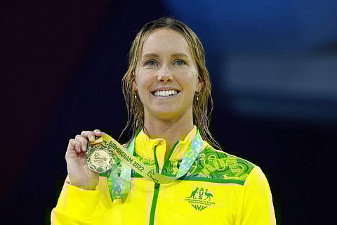 Australia's Emma McKeon holds her gold medal on the podium during the medal ceremony for the Women's 50m Freestyle during the swimming at the Commonwealth Games. (Photo | AP)