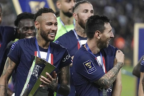 PSG's Neymar, left, holds the trophy as he celebrate with his teammate Lionel Messi after winning the French Super Cup final soccer match between Nantes and Paris Saint-Germain. (Photo | AP)