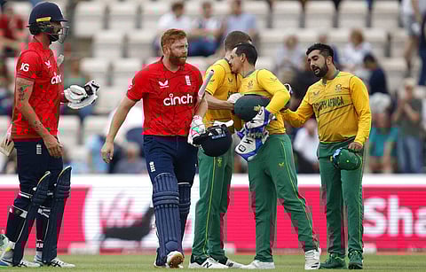 England's batsman Reece Topley, left, with teammate Jonny Bairstow, second, watch as South Africa's players celebrates at the end of the 3rd T20. (Photo | AP)