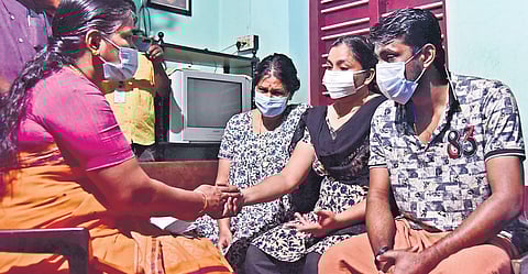 BJP leader Sobha Surendran consoles the family of Mukundan who ended his life after Karuvannur Cooperative Bank was served a revenue recovery notice. (Photo | Albin, EPS)