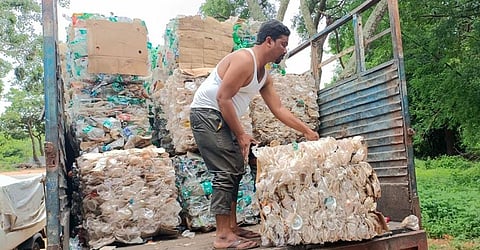 A Swachh Sevak loads the compressed plastic waste strewn by visitors to the  Amrabad Tiger Reserve on a truck