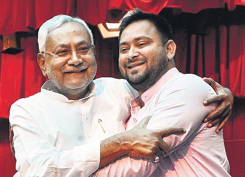 Bihar Chief Minister Nitish Kumar with his deputy Tejashwi Prasad Yadav after their swearing-in ceremony at Raj Bhavan in Patna on Wednesday (Photo | PTI)