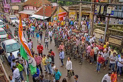 People gather outside the residence of Trinamool Congress leader Anubrata Mandal during CBI raids in connection with a cattle smuggling case, at Bolpur in Birbhum. (Photo | PTI)