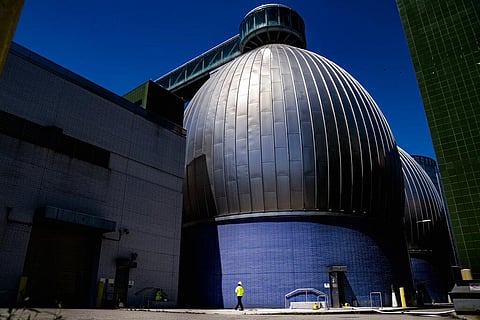 A worker walks alongside the Newtown Creek Wastewater Treatment Plant's array of digester eggs, Friday, Aug. 12, 2022. (Photo | AP)