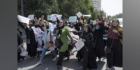 Afghan women hold placards as they march and shout slogans 'Bread, work, freedom' during a womens' rights protest in Kabul. (Photo | AP)