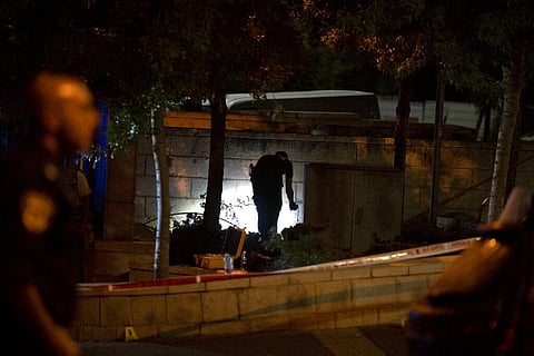 An Israeli police crime scene investigator works at the scene of a shooting attack that wounded several Israelis near the Old City of Jerusalem. (Photo | AP)