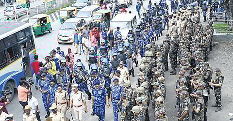 Rapid Action Force and City Armed Reserve personnel march on a road in Chamarajpet on Sunday. (Below) Police personnel rehearse at the Chamarajpet Idgah Maidan in Bengaluru on Sunday | Nagaraj Gadekal