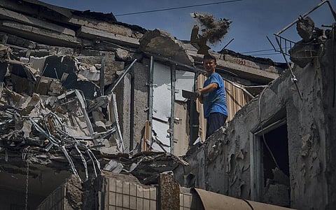 A man cleans an apartment destroyed after Russian shelling in Nikopol, Ukraine, Monday, Aug. 15, 2022. (Photo | AP)