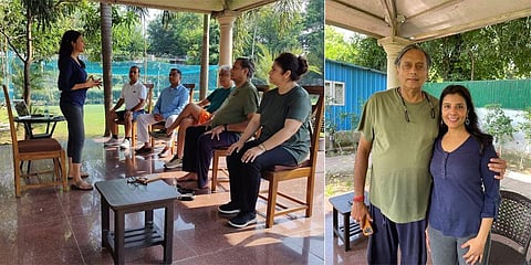 Mita Vinay (standing) briefing the participants, including Shashi Tharoor, on the session, ‘Yoga Beyond Mats’
