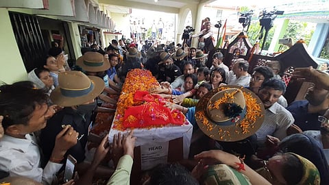 Family members stretch their arms out to touch the coffin containing the remains of Chandra Shekhar, Wednesday, Aug. 17, 2022 (Photo | AP)