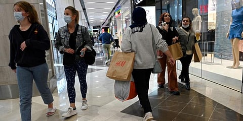 People walk in a shopping mall. (Photo | AFP)