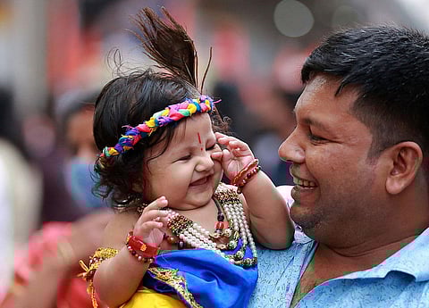  A child dressed up as Lord Krishna seen at the Sri Krishna Janmashtami procession held at MG Road in Kochi, Kerala. 