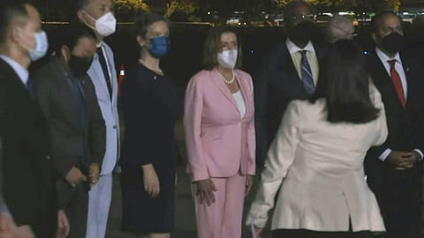 US House Speaker Nancy Pelosi (C) walking with officials after landing in Taipei Songshan Airport. (Photo | AFP)