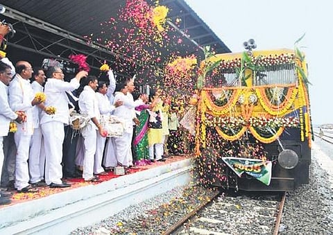 Finance Minister  T Harish Rao and others  welcome  the first  goods train carrying 948 tonnes of fertilisers  at Medak railway station on Monday