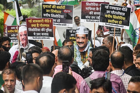 Congress workers hold placards during their protest demanding resignation of Delhi Deputy Chief Minister Manish Sisodia, outside AAP's office in New Delhi. (Photo | PTI)