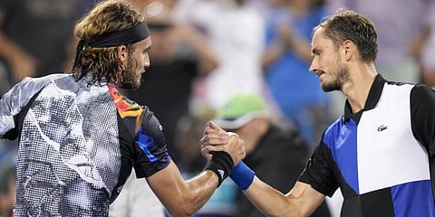 Stefanos Tsitsipas, left, shakes hands with Medvedev, after their semifinal match of the Western & Southern Open.(Photo | PTI)