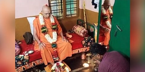 A member of the Muslim family offers pada puja to the seer in Gadag. (Photo | Express)