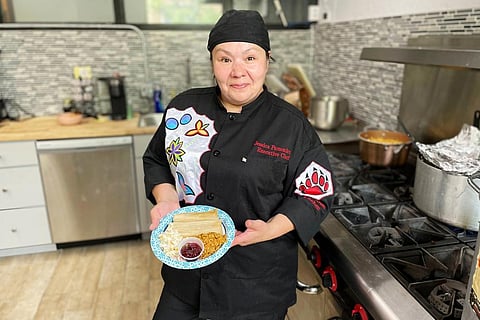 Jessica Pamonicutt, executive chef of a Native American catering company in Chicago, displays the contemporary indigenous meal she cooked. (Photo | AP)
