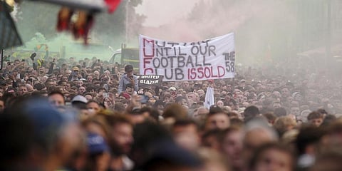 Fans gather to protest against the Manchester United owners outside the Old Trafford ground, Manchester, England, Aug. 22, 2022.(Photo | AP)
