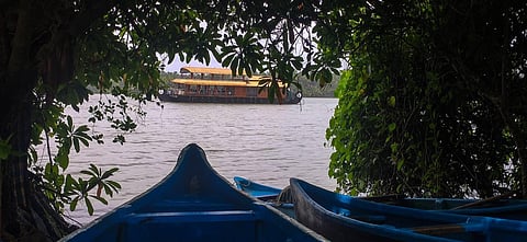 A houseboat taking domestic tourists on a leisure trip in the Kavvayi Backwaters hemming Valiyaparamba panchayat.