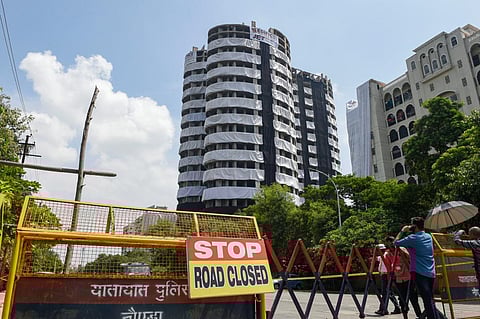 Barricades used to block a road leading to Supertech twin towers ahead of their demolition with explosives in compliance with a Supreme Court order. (Photo | PTI)