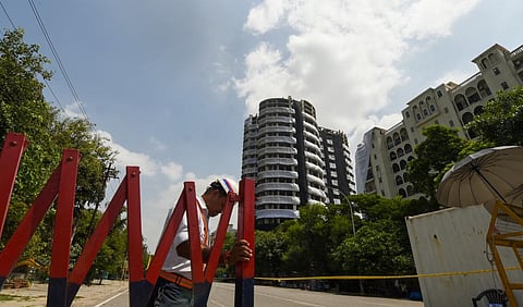 Barricades used to block a road leading to Supertech twin towers ahead of their demolition with explosives in compliance with a Supreme Court order, in Noida. (Photo | PTI)